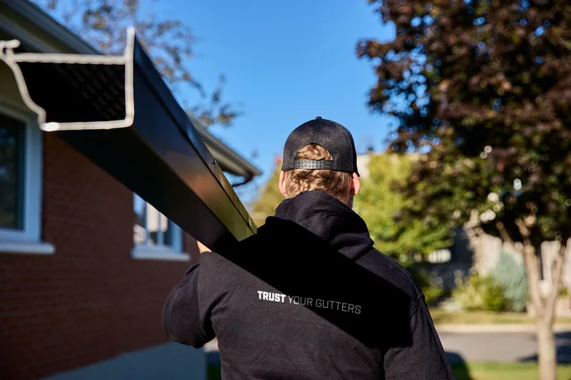 Seamless aluminum gutter installation on an Erie home